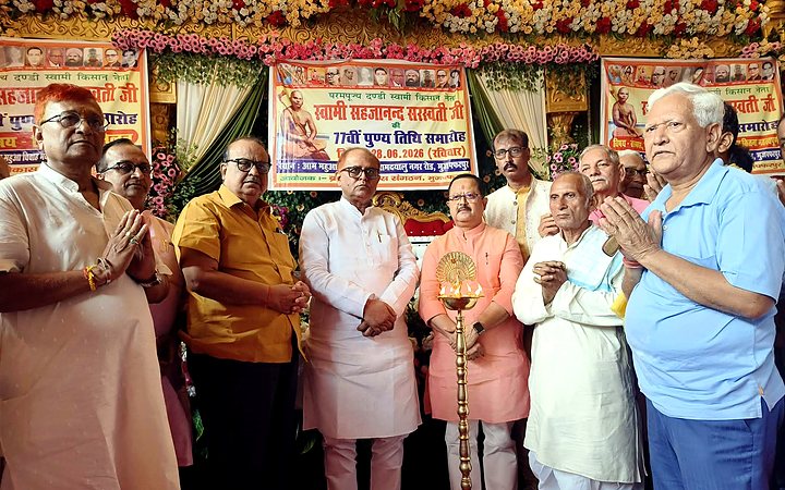 Guests standing near ceremonial lamp