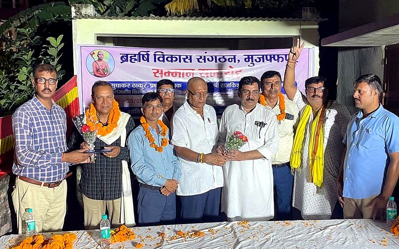 Honorees with garlands at night event