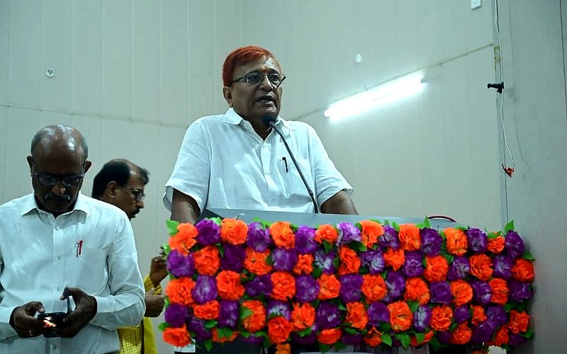 Speaker at podium with floral decoration